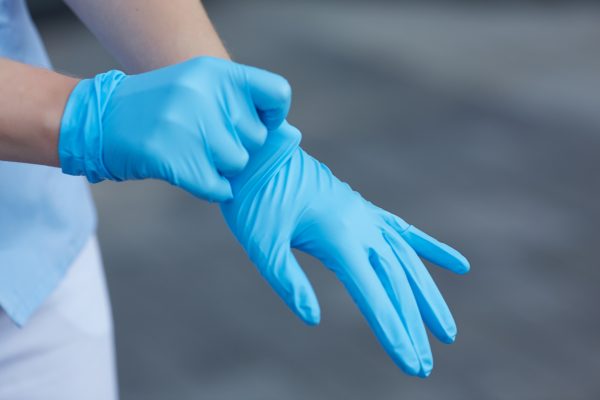 woman doctor wears medical gloves