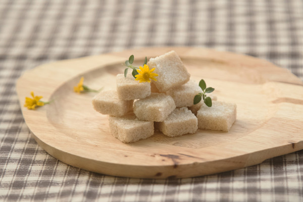 Brown sugar cube on wooden plate