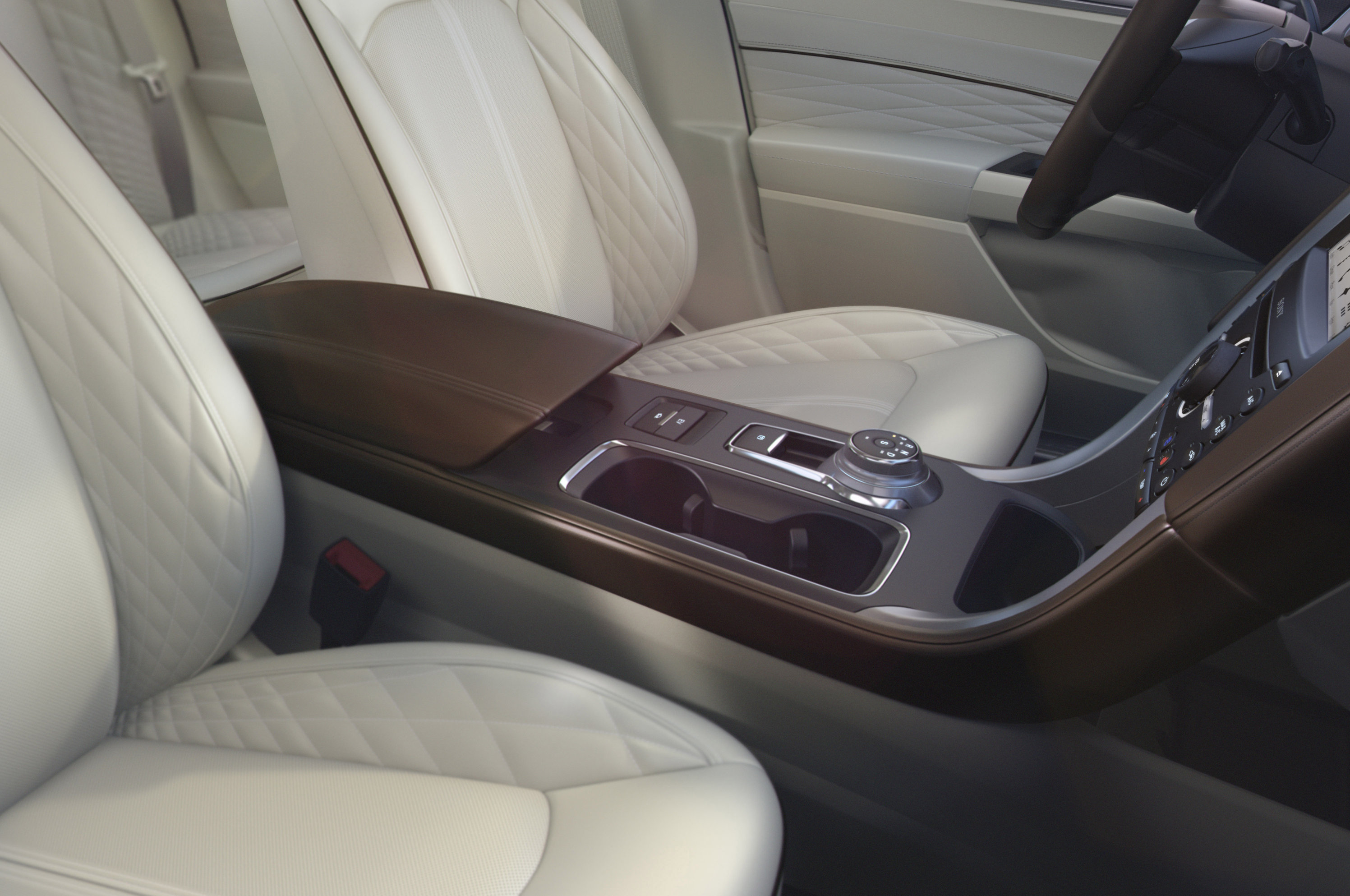 The center console of the new 2017 Ford Fusion includes a rotary gear shift dial and two relocated cup-holders.