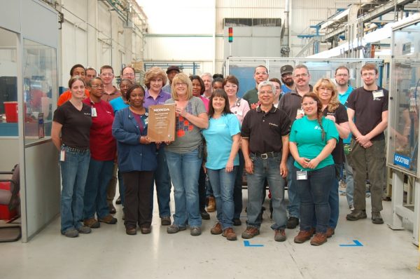 Employees from BorgWarner's manufacturing facility in Seneca, South Carolina, proudly display their latest Excellence in Quality Award from Honda North America. Since 2002, the plant has earned 12 supplier awards from Honda, including seven awards for quality, four for delivery and one for engineering innovation. (PRNewsFoto/BorgWarner Inc.)