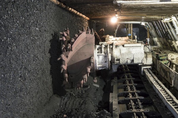 Underground mine excavator facing coal wall .
