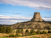 Devils Tower, a flat rocky butte stands tall above the surrounding land.