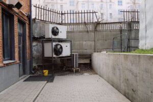 Image of outdoor air conditioning unit in urban industrial courtyard