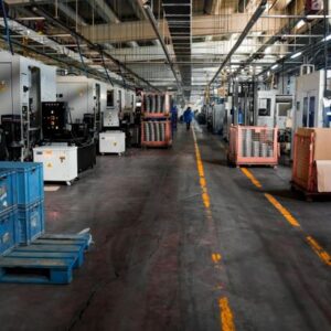 Image of industrial factory floor with machinery, crates and structured workstations